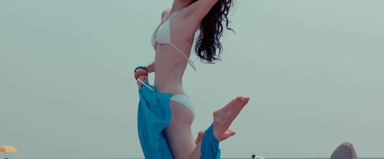 woman in bikini jumping